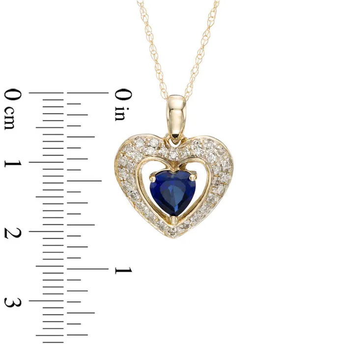 50mm HeartShaped LabCreated Blue Sapphire and 013 CT TW Diamond Frame Heart Pendant in 10K Yellow Gold Goldia Necklaces 50mm HeartShaped LabCreated Blue Sapphire and 013 CT TW Diamond Frame Heart Pendant in 10K Yellow Gold Goldia Necklaces